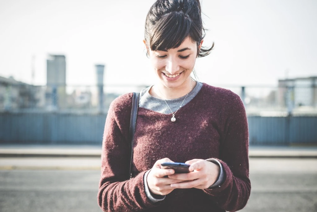 Adult using a phone to explore ADHD testing options